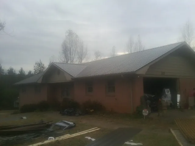 Gray metal roof on a stucco house with an attached garage in Venice